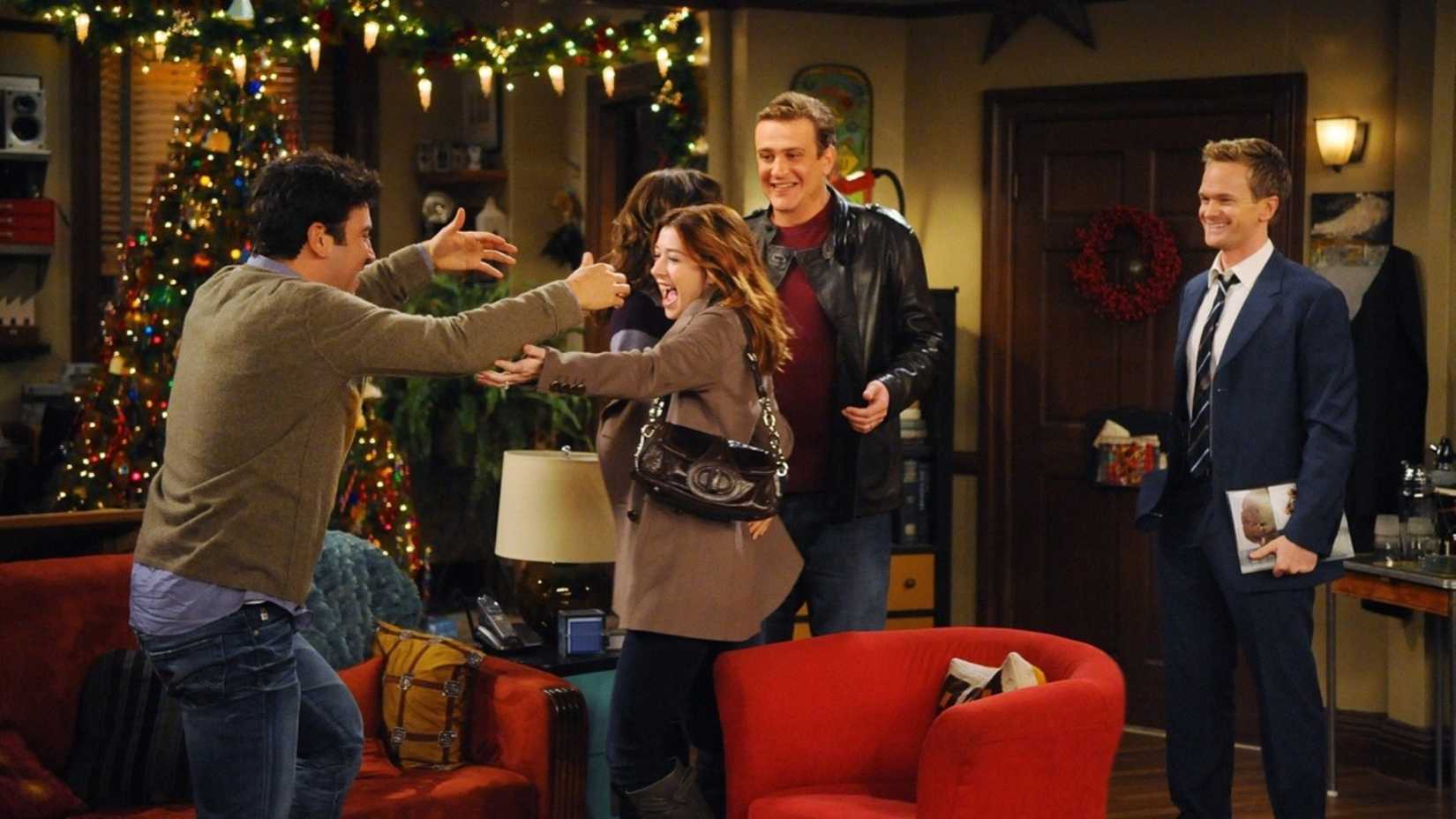 The gang celebrating Lily's pregnancy in the apartment in How I Met Your Mother.
