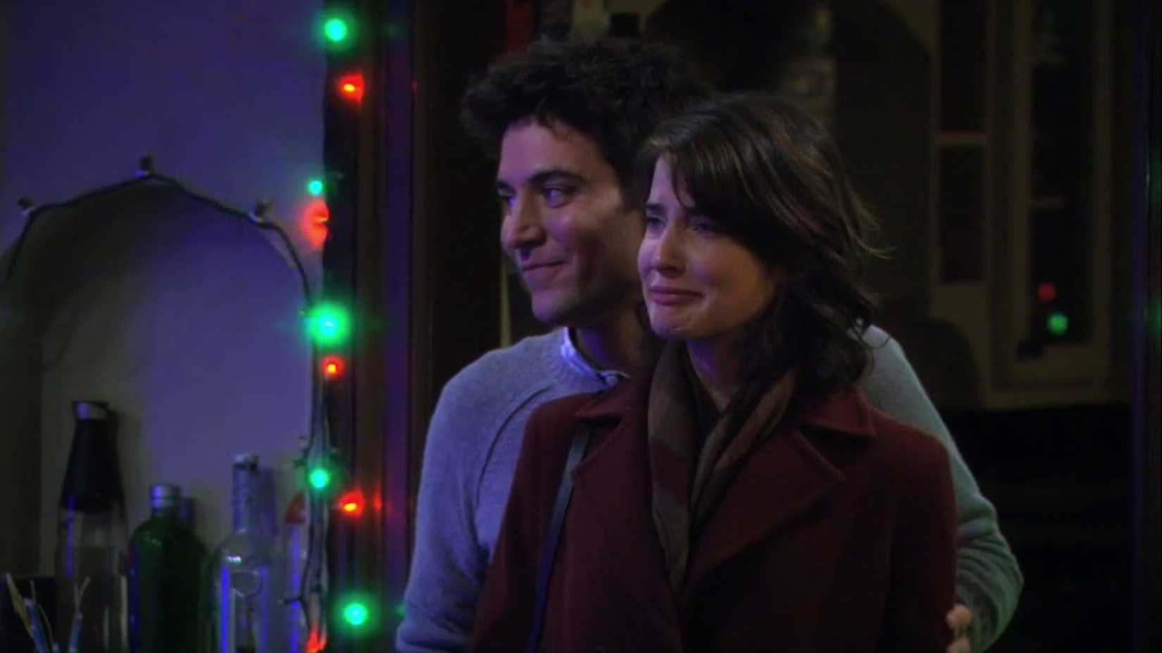 Ted holding a crying Robin as they watch the Christmas light display in How I Met Your Mother.