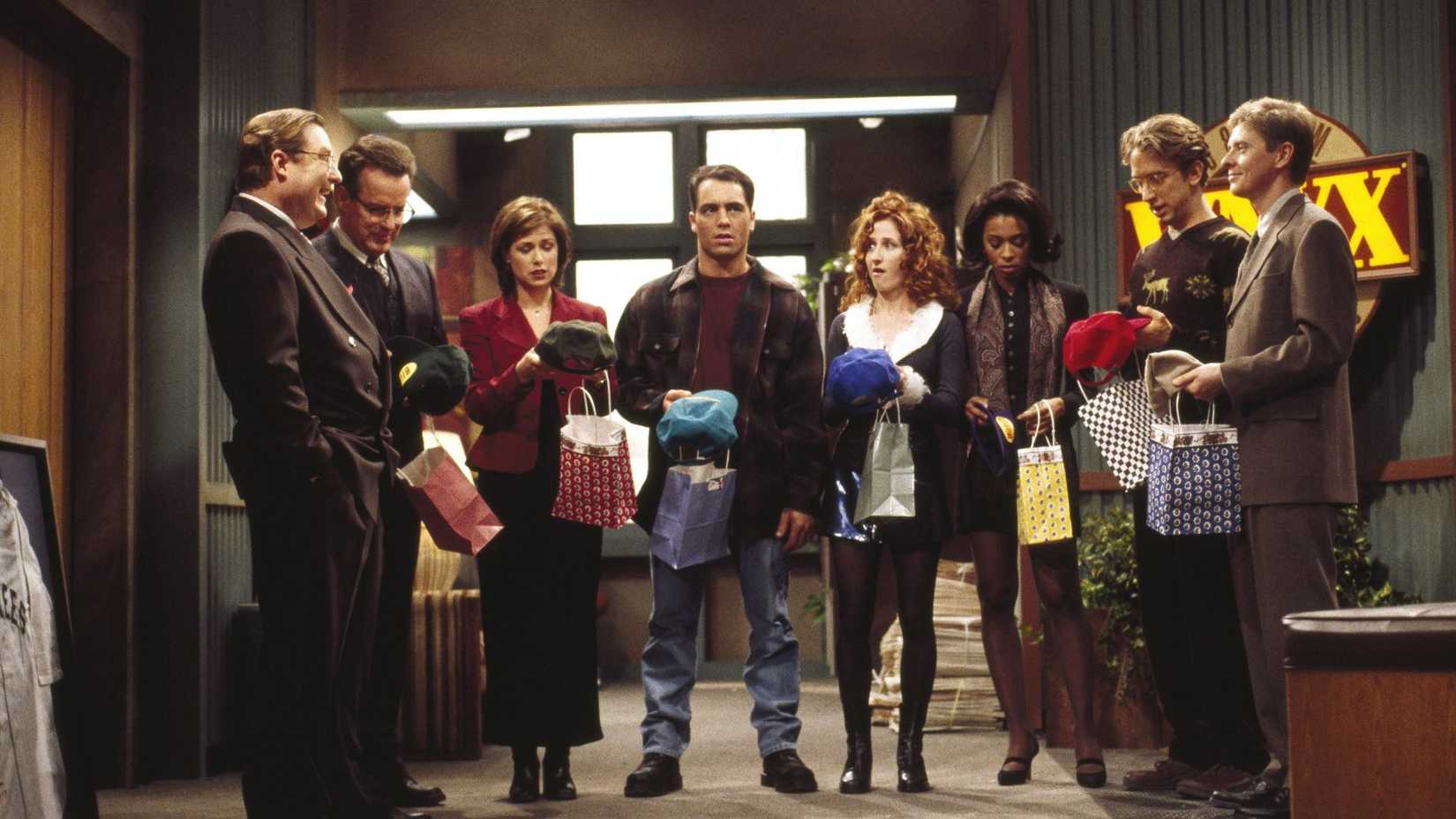 The cast of News Radio, Including Andy Dick, second to far fight, across from Phil Hartman