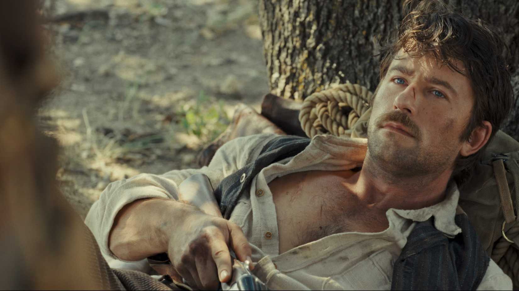 Spencer lies by a tree in 1923