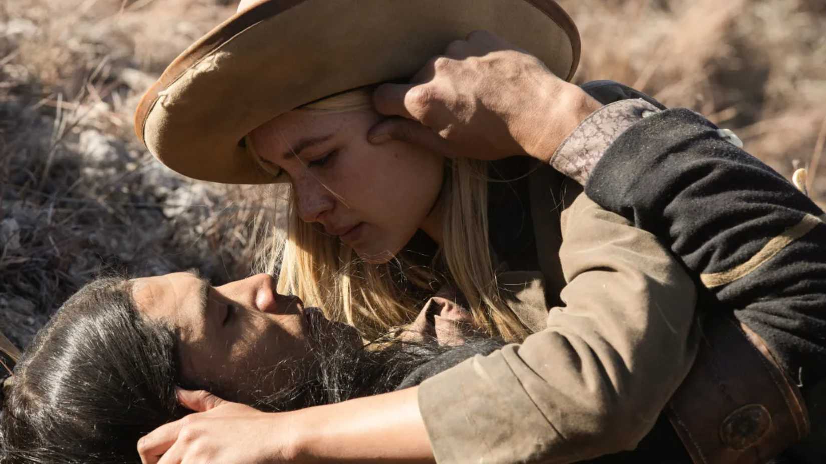 Elsa and Sam embrace on the ground in 1883