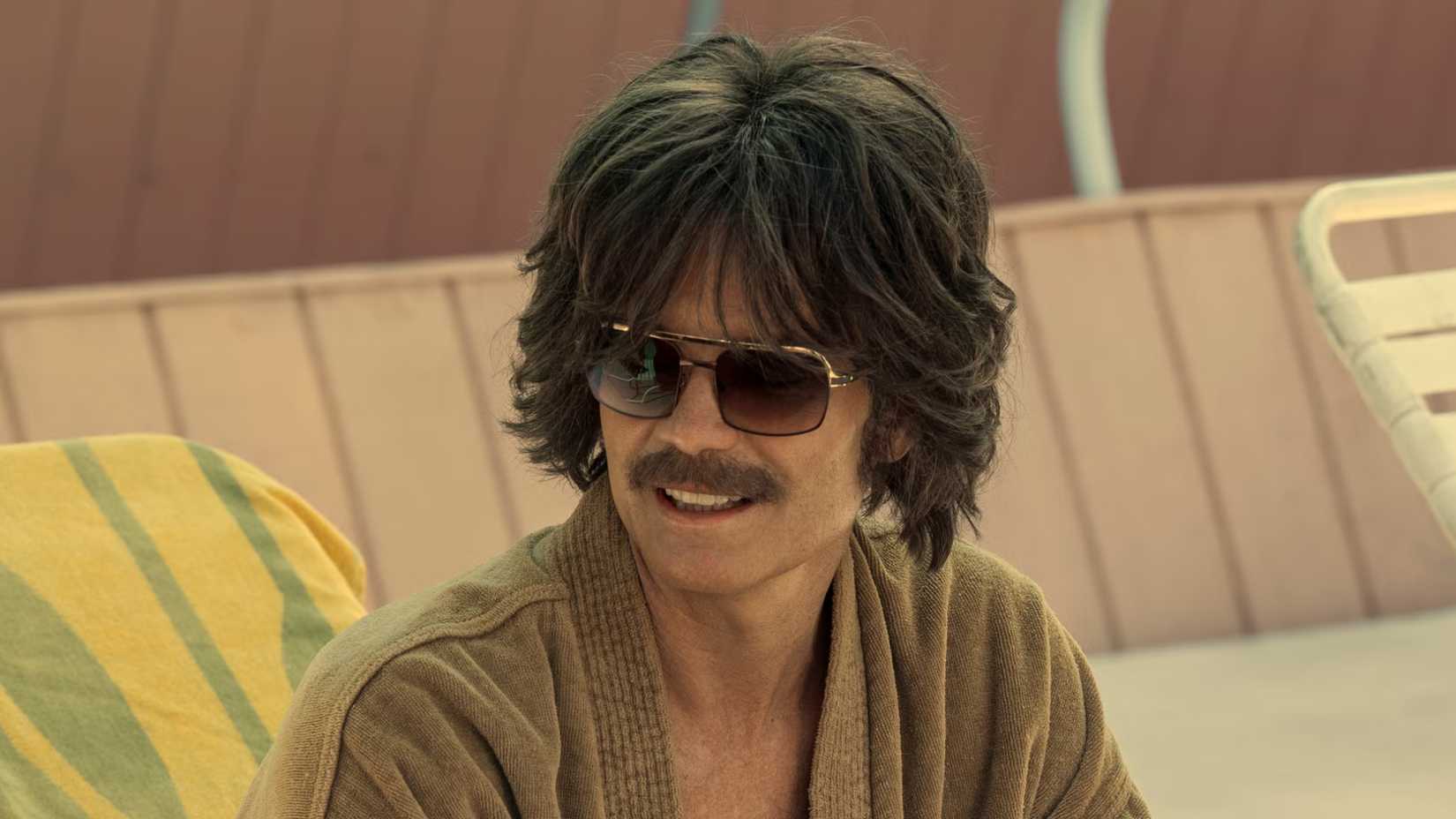 Rod smiles on a pool chair in Daisy Jones & The Six