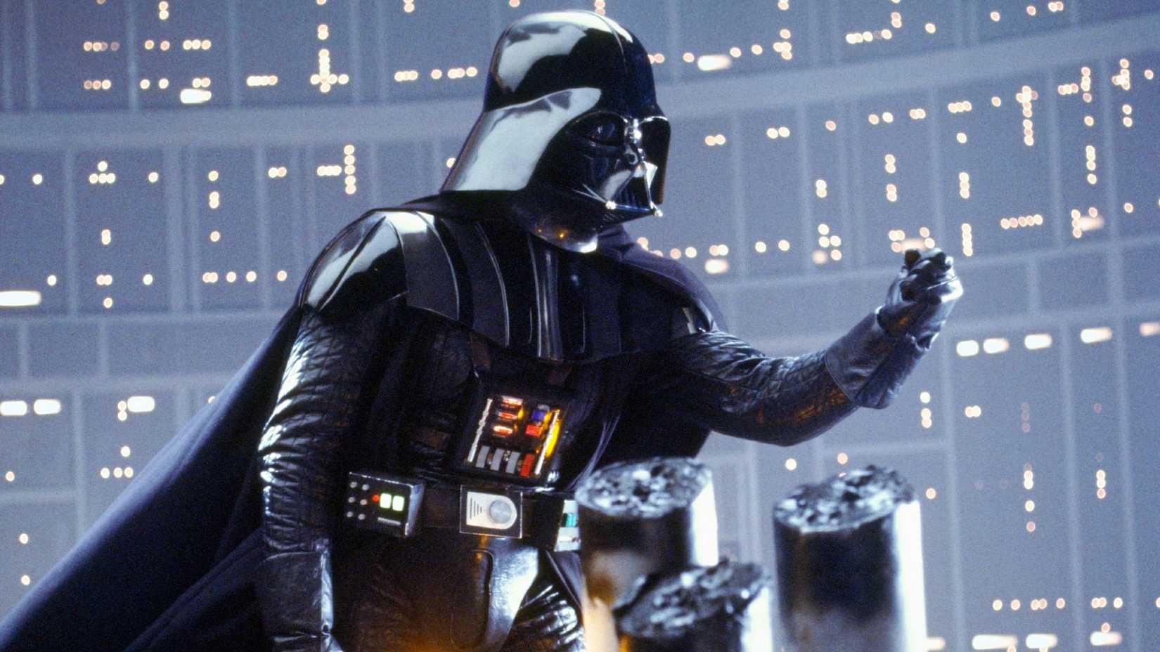 Darth Vader holding his hand out while fighting with Luke in Star Wars The Empire Strikes Back.