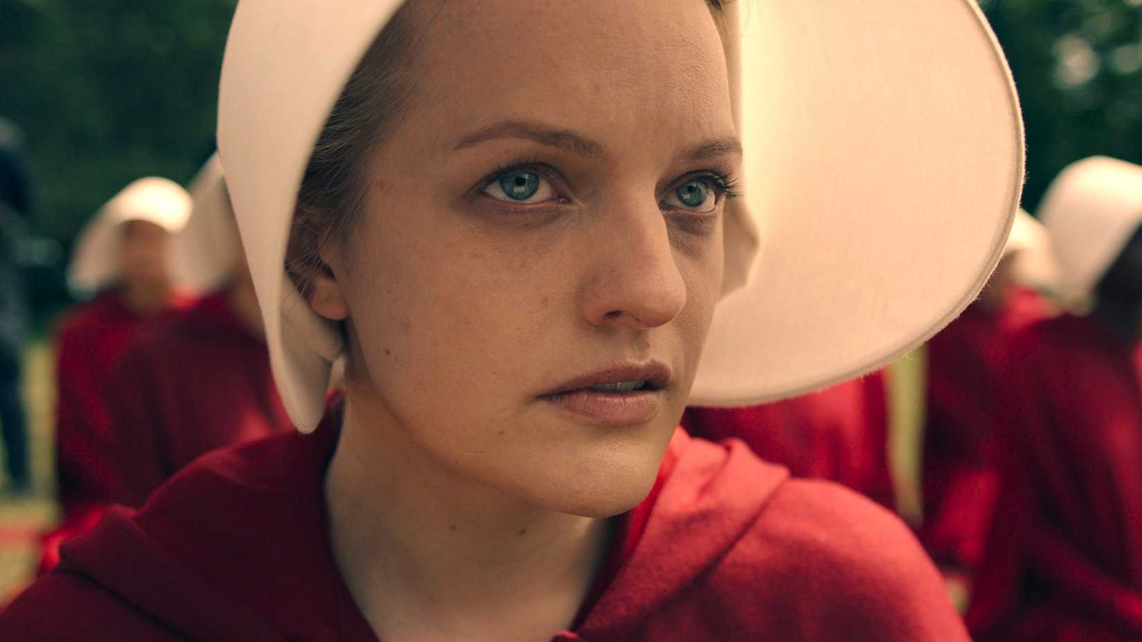 Elisabeth Moss as Offred staring off at something in The Handmaid's Tale.