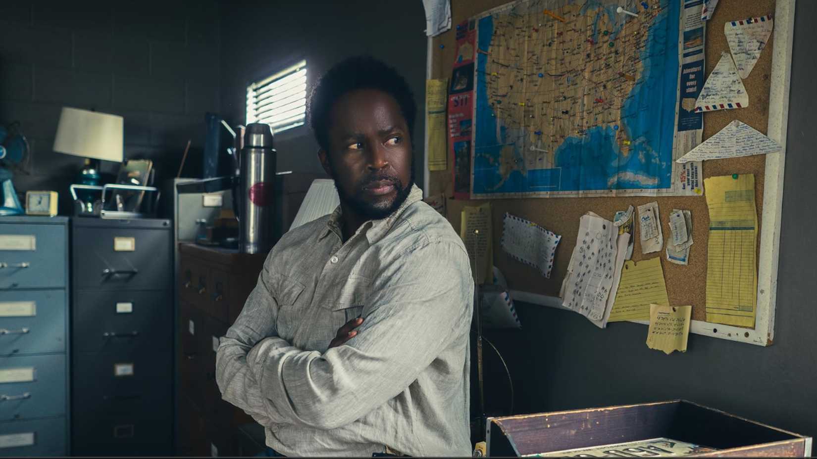 Harold Perrineau standing in an office in From