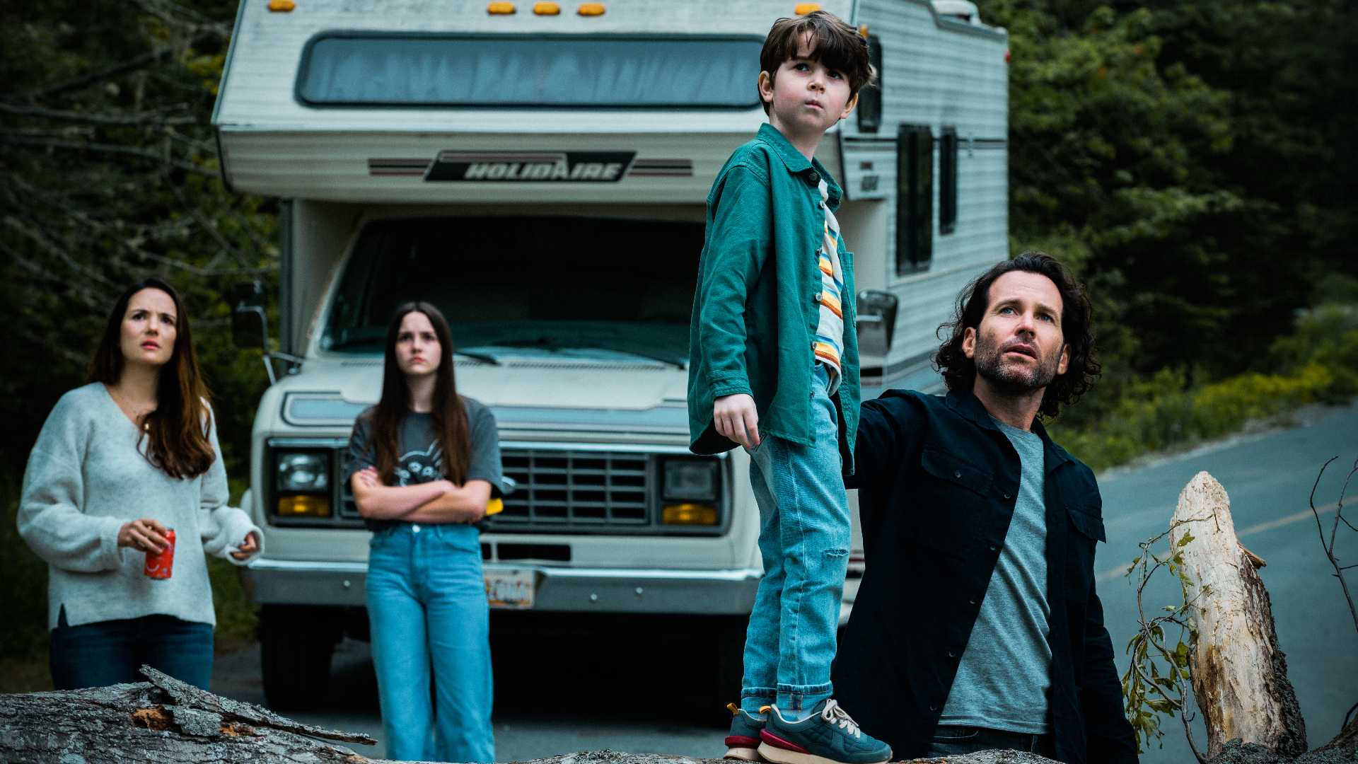 The Matthews family stands by an RV in From
