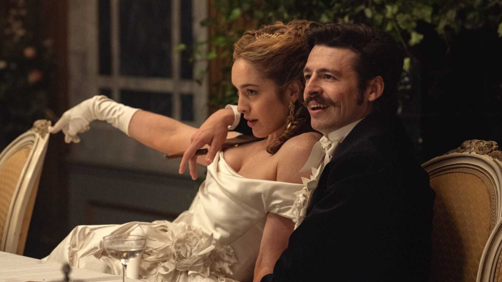 Arthur and Olivia sit on a sofa in House of Guinness