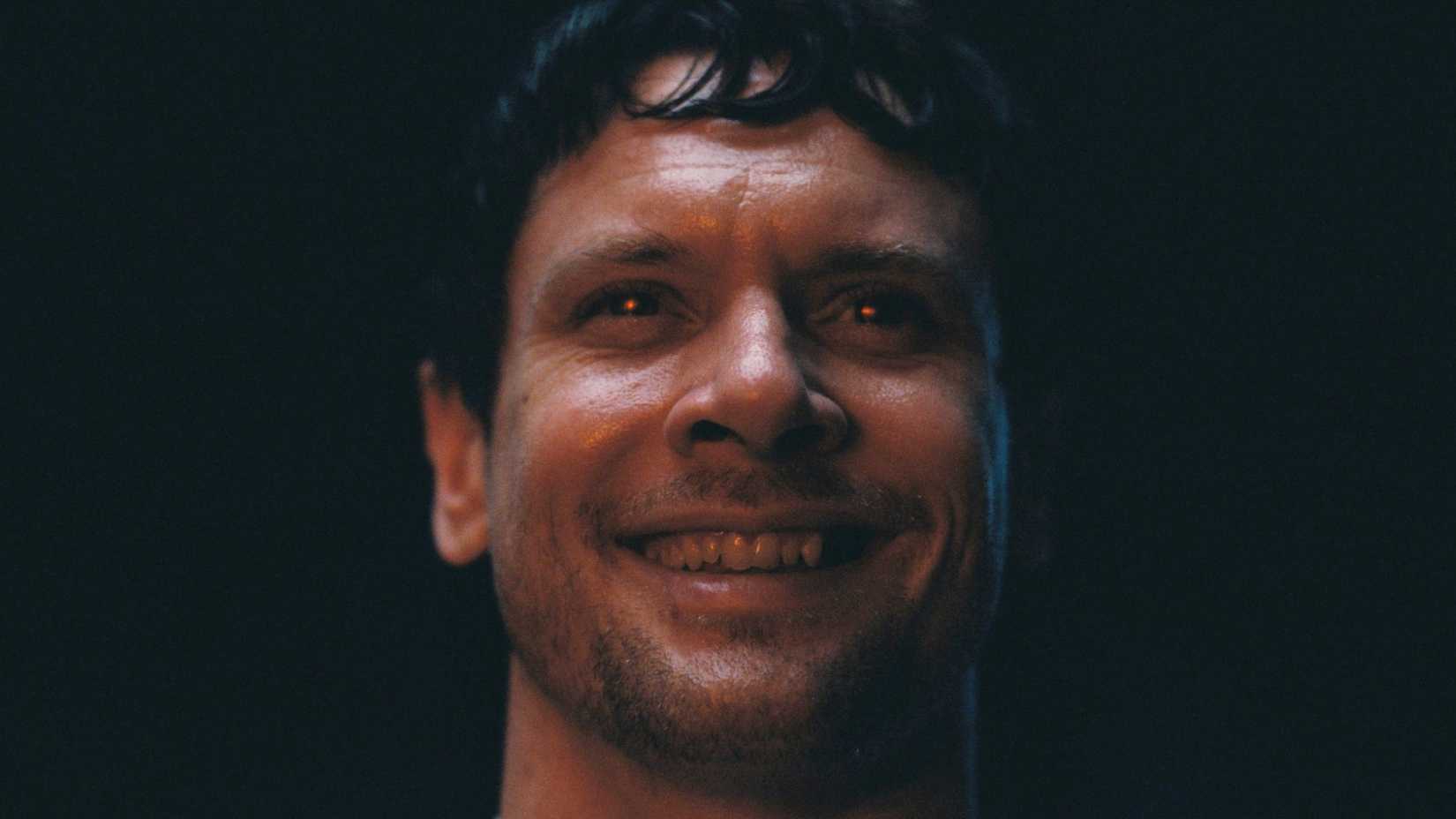 Jack O'Connell smiles in Sinners