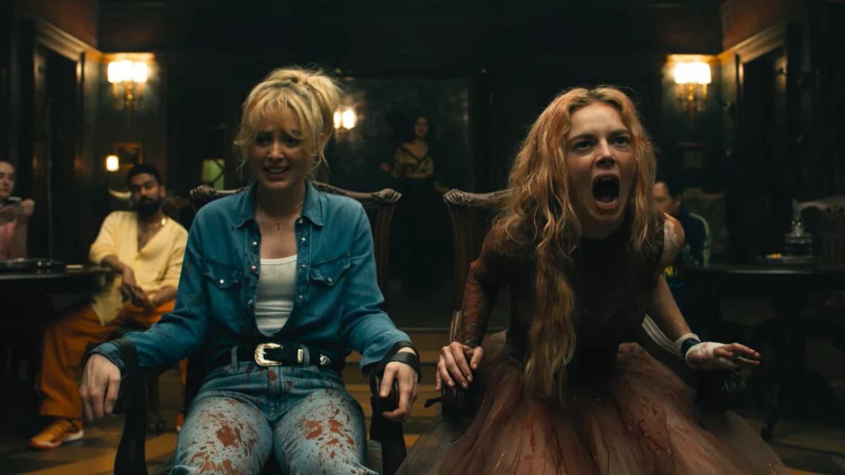 Kathryn Newton and Samara Weaving tied to chairs in Ready or Not 2.