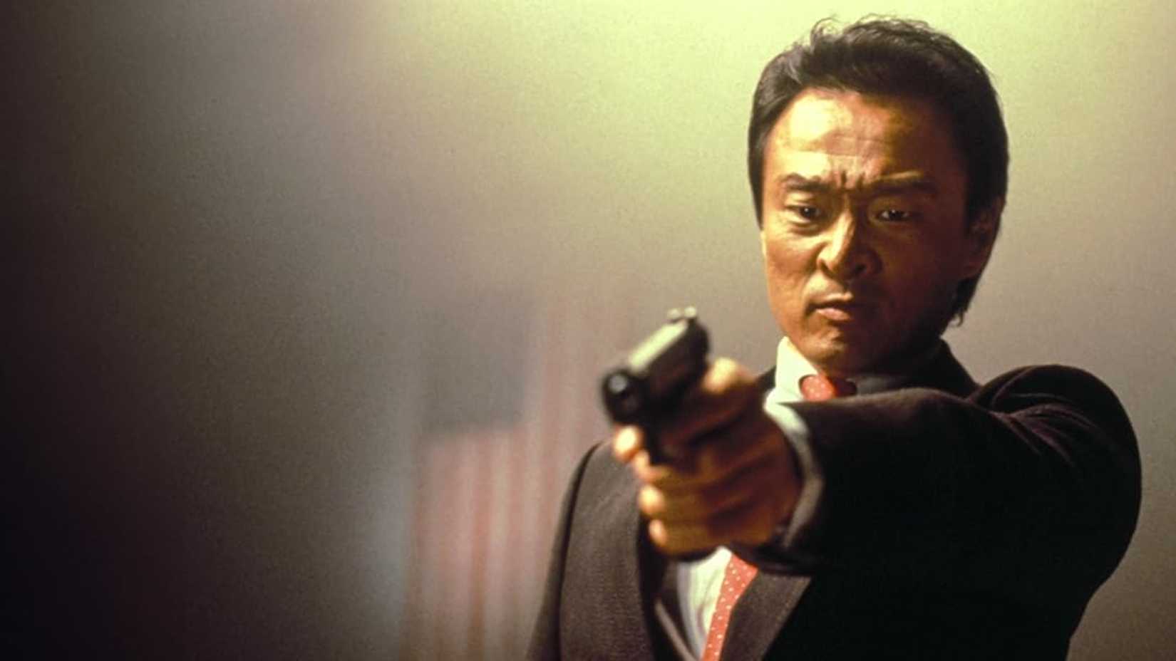 Cary-Hiroyuki Tagawa holding a gun from Kickboxer 2