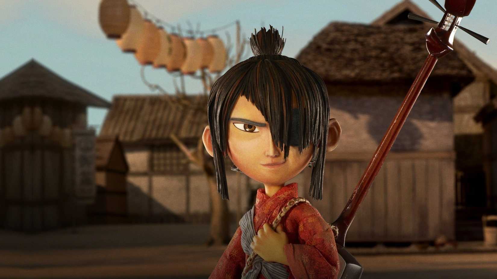 Kubo holding his guitar in front of the Japanese village in Kubo and the Two Strings