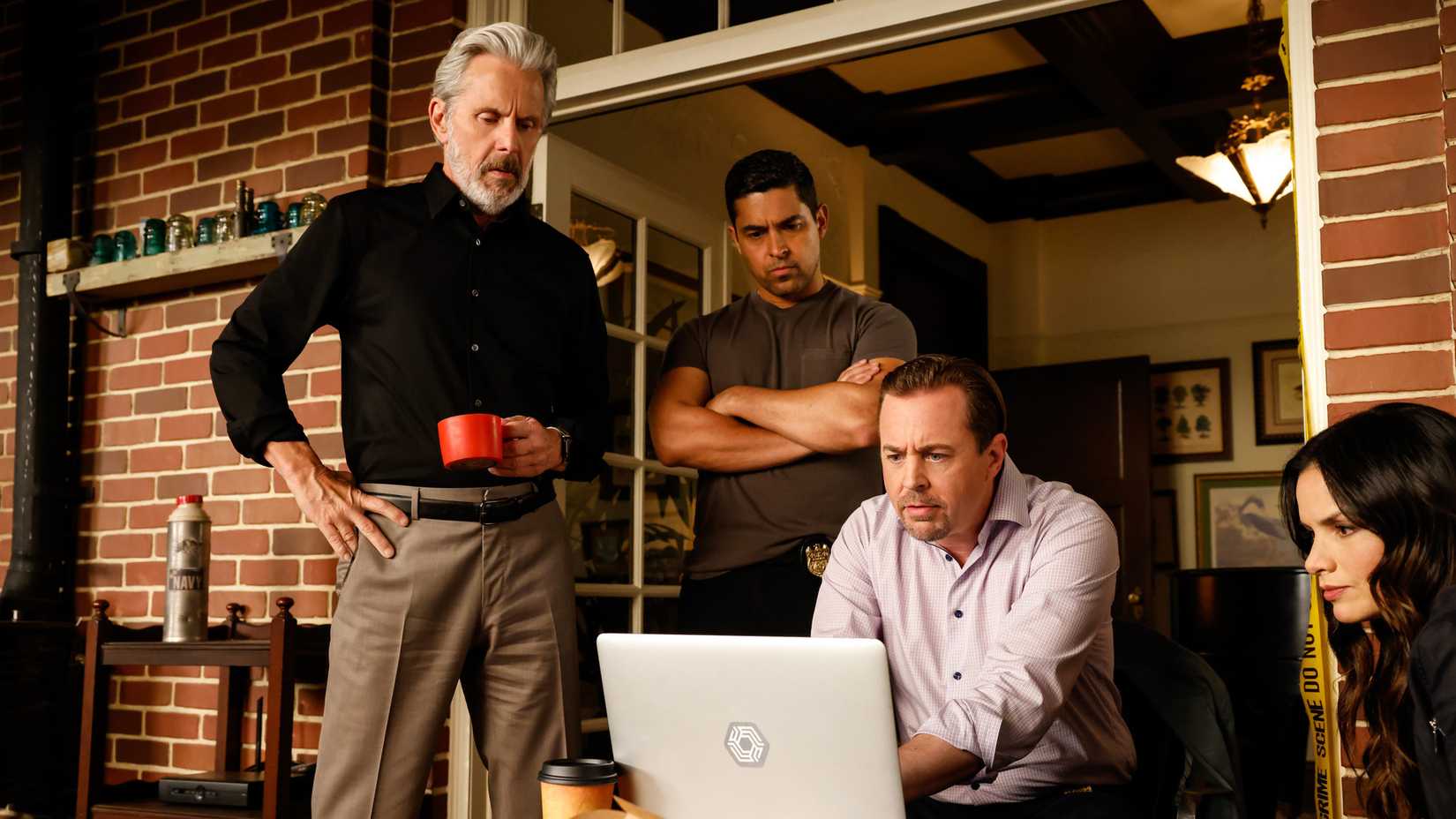 NCIS team looking at a laptop