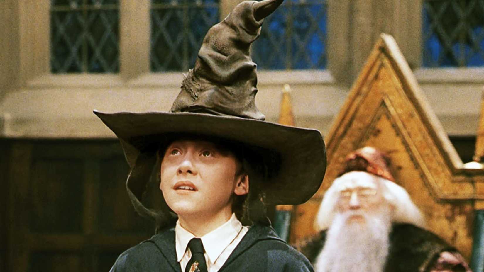 Ron with the Sorting Hat on his head in Harry Potter