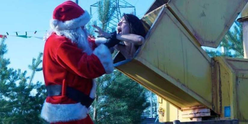 Santa putting someone in a woodchipper in Silent Night (2012)