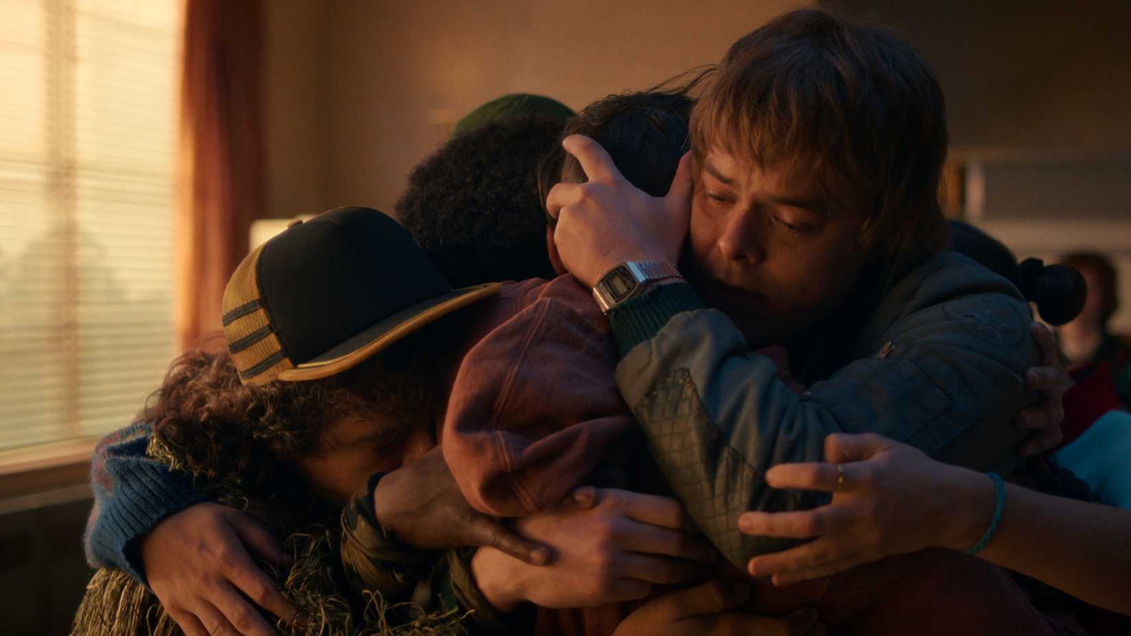 Everyone crowding and hugging Will in Stranger Things.
