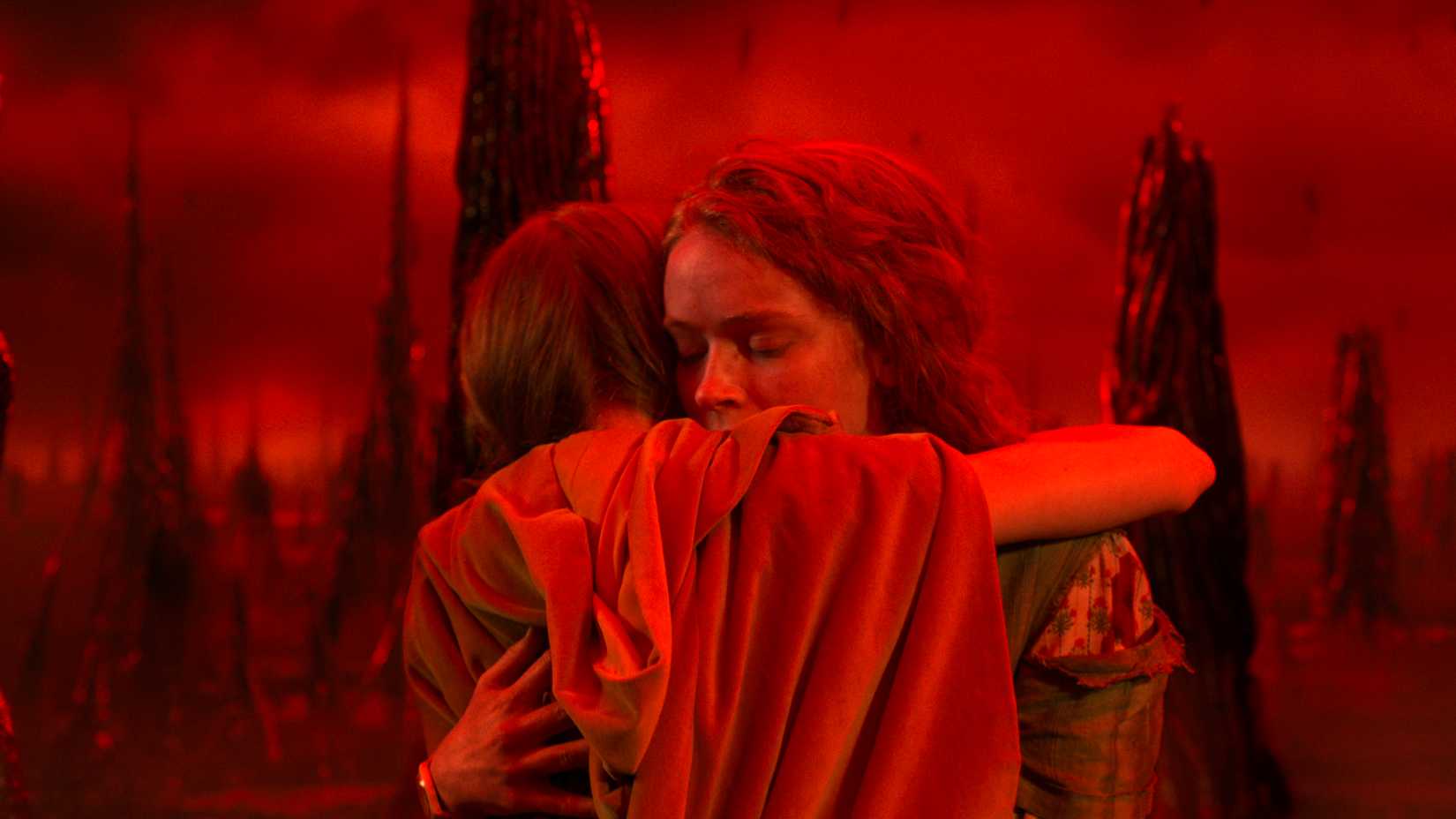 Max hugging Holly in the Upside Down in Stranger Things.