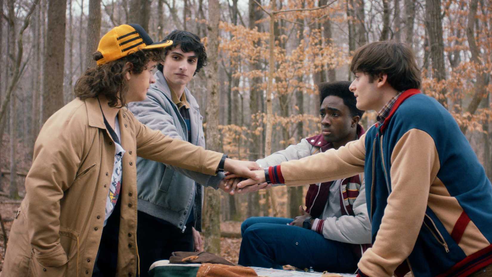 Stranger Things Season 5 boys touch hands in the forest