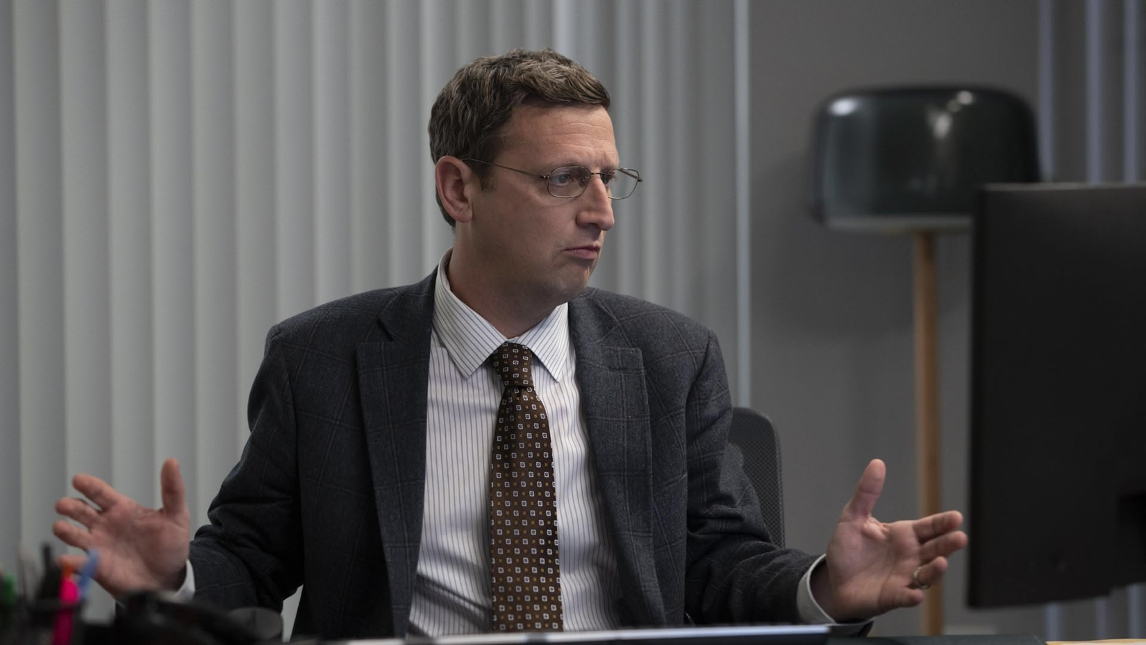Tim Robinson sitting in front of a computer