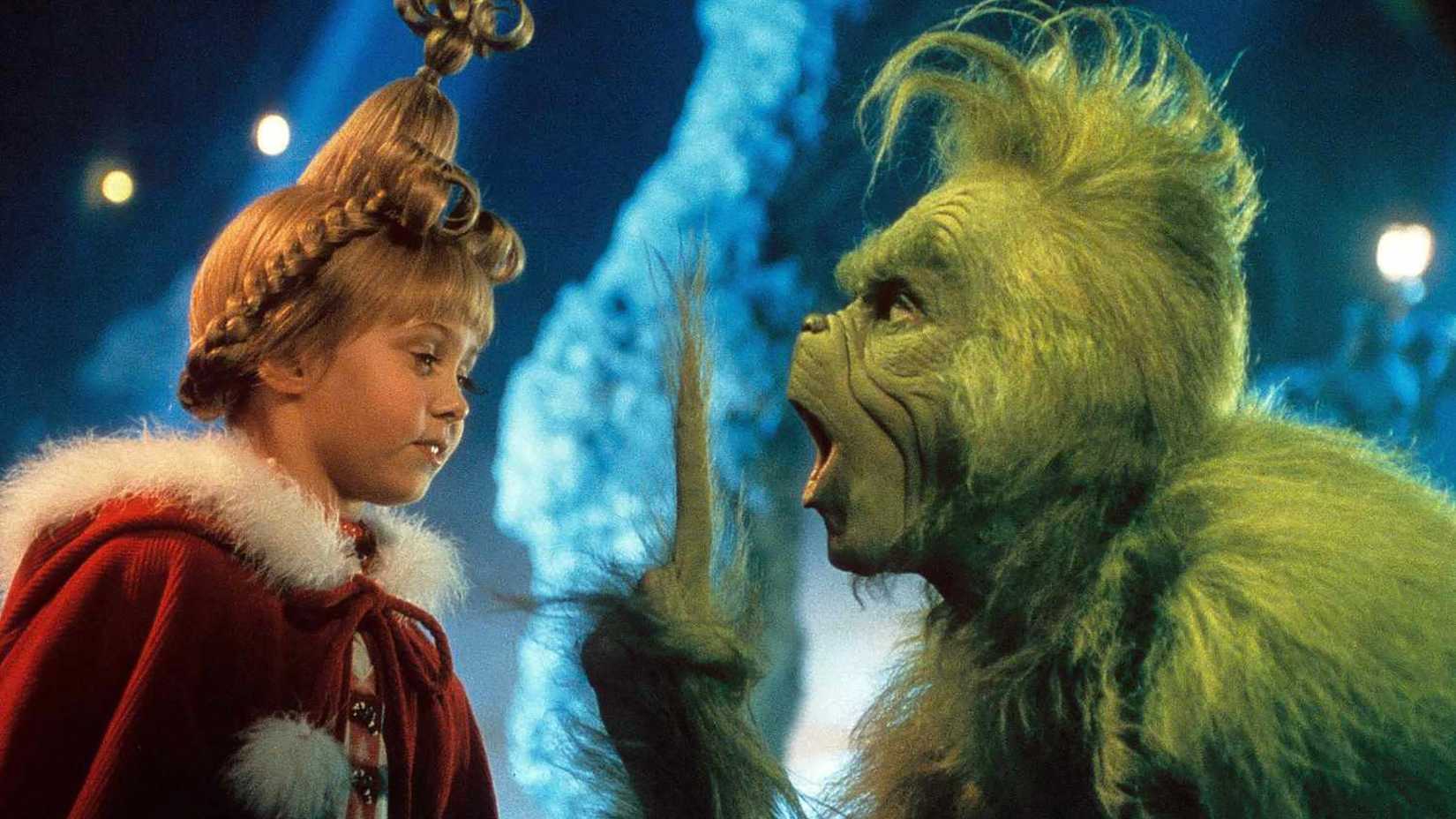 The Grinch bending down holding out a finger to Cindy Lou in How the Grinch Stole Christmas.