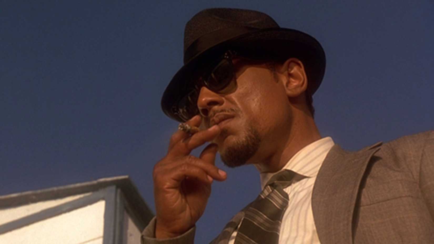 Jack holds a cigarette in his glasses and a fedora in The Usual Suspects