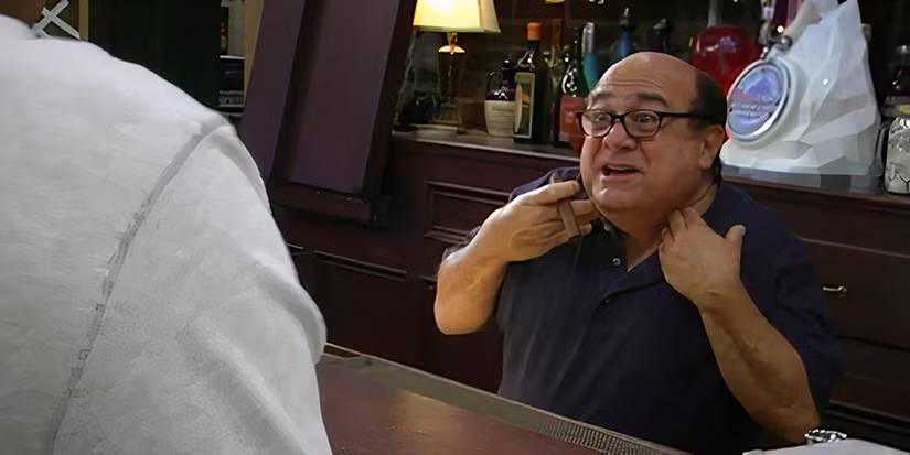 Frank Reynolds pointing at his neck as he tells Dennis and Dee that their mother is dead in It's Always Sunny in Philadelphia.
