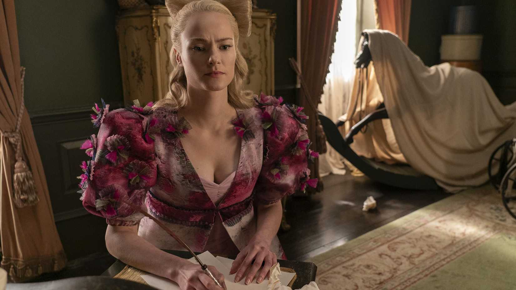 Cressida Cowper trying to write a Lady Whistledown issue while sat in her home in Bridgerton.