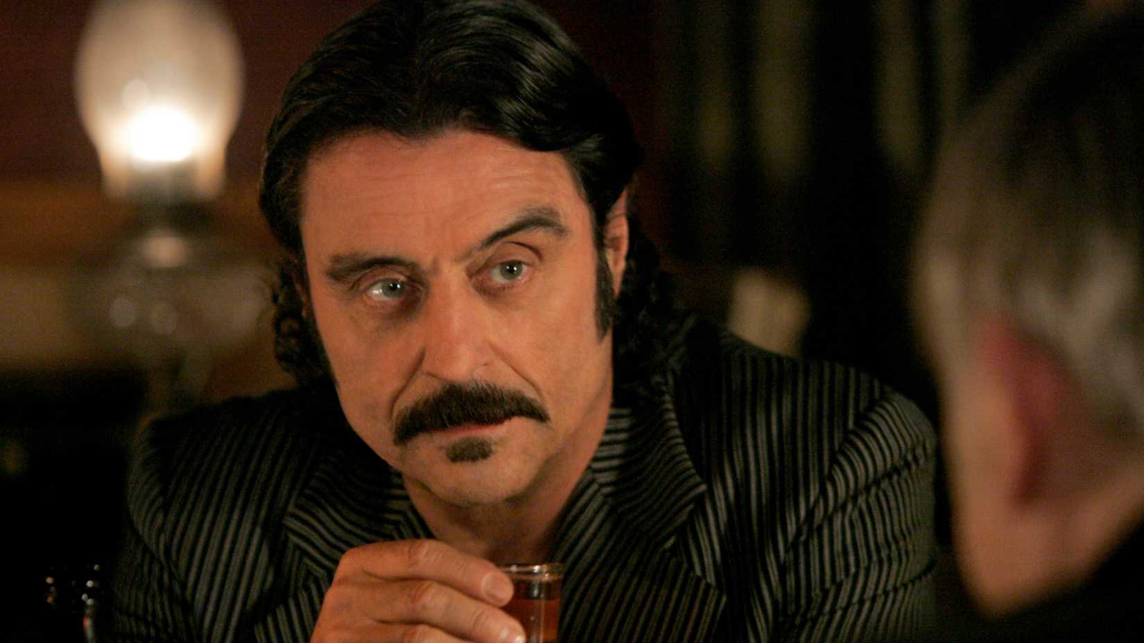 Al holds a shot glass in Deadwood