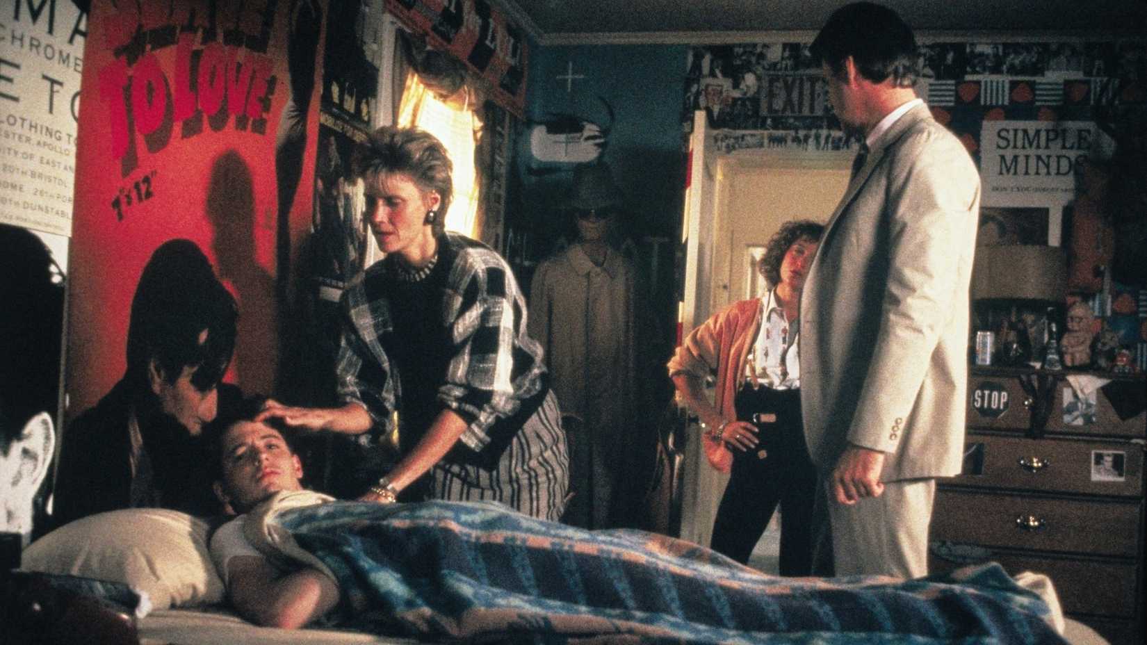 Ferris Bueller sick in bed with family checking on him.