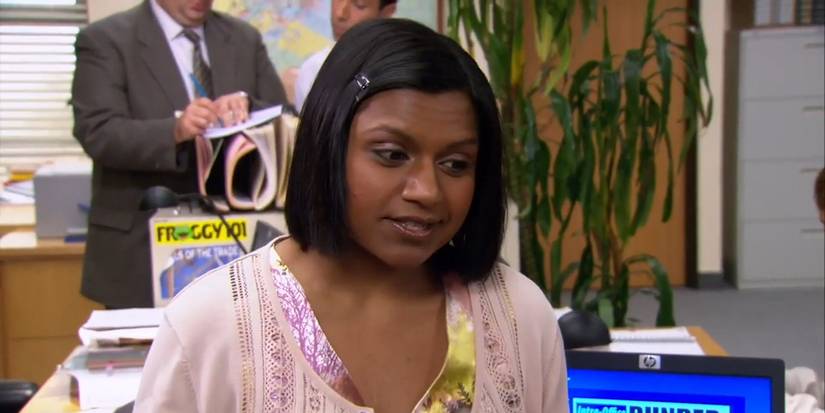 Kelly sitting on Ryan's desk as she explains the Netflix DVD process in The Office.