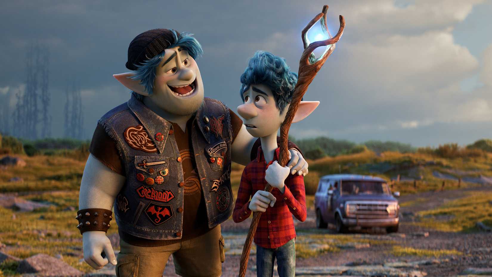 Ian carrying a staff while Barley talks to him in an open field in Onward.