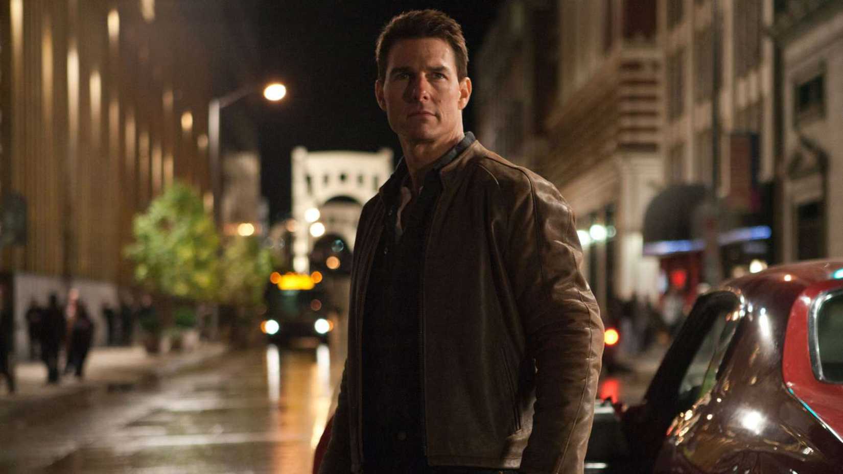 Jack stands in the street in Reacher