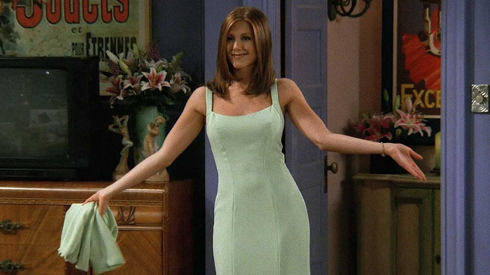Rachel Green showing off her green dress after finally getting ready for Ross' event in Friends.