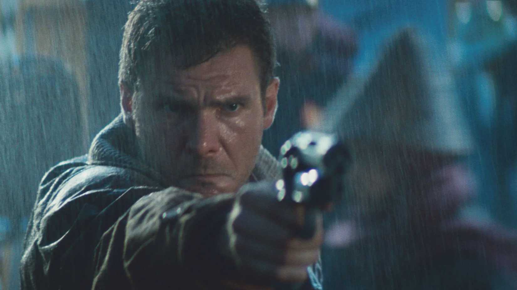 Deckard aims a gun in the rain in Blade Runner