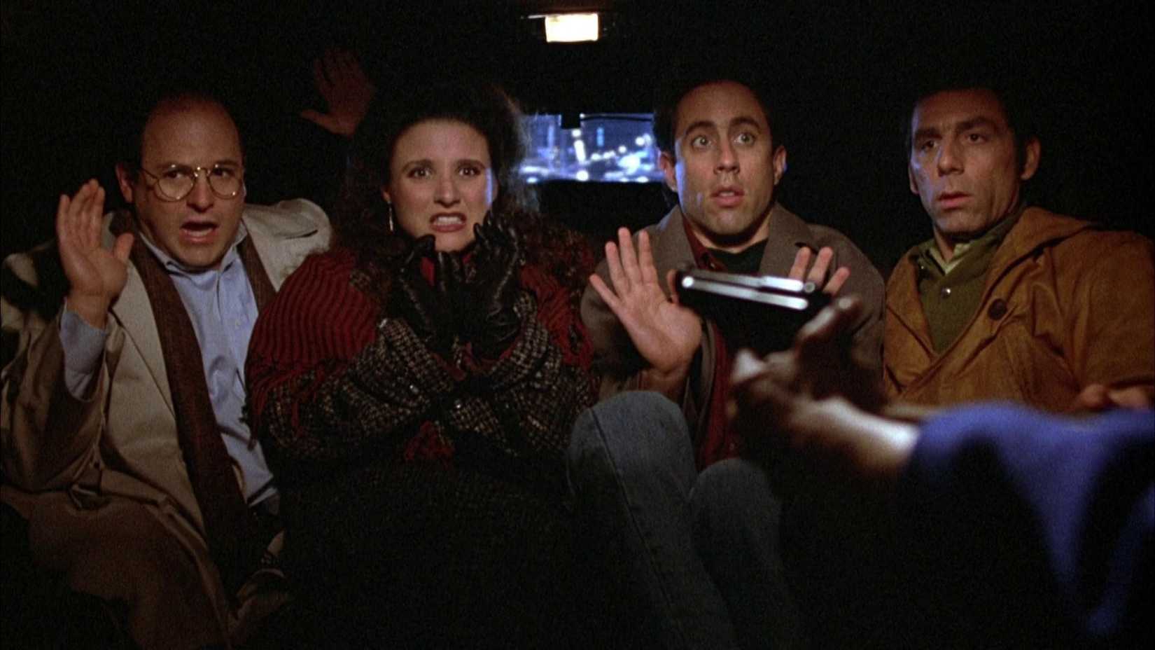 seinfeld characters in a limo with a gun pointed at them