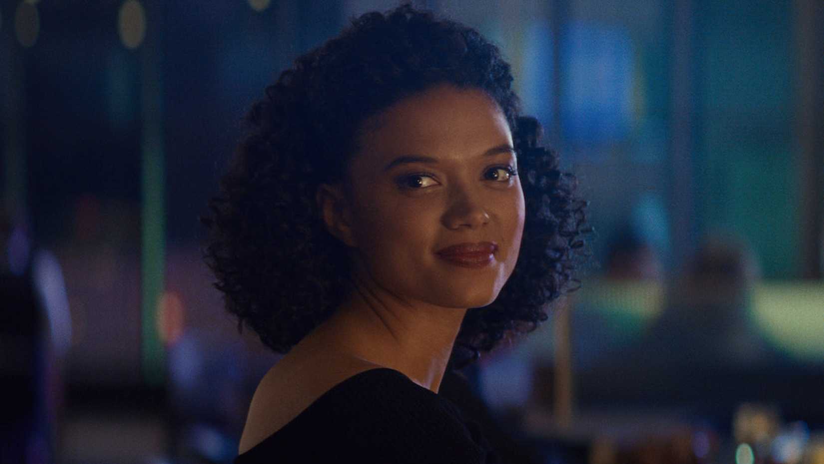 Sandra smiles by a window in Sharper