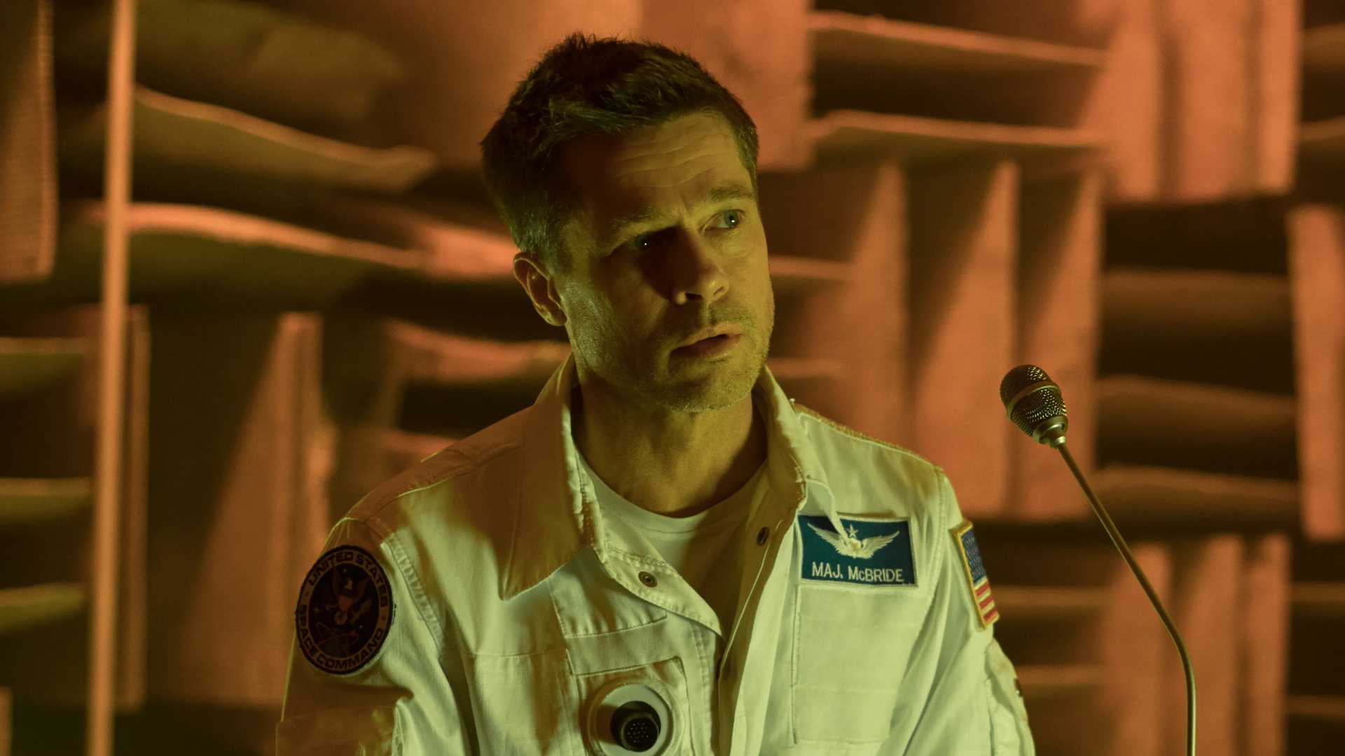 Brad Pitt speaks on a microphone in Ad Astra