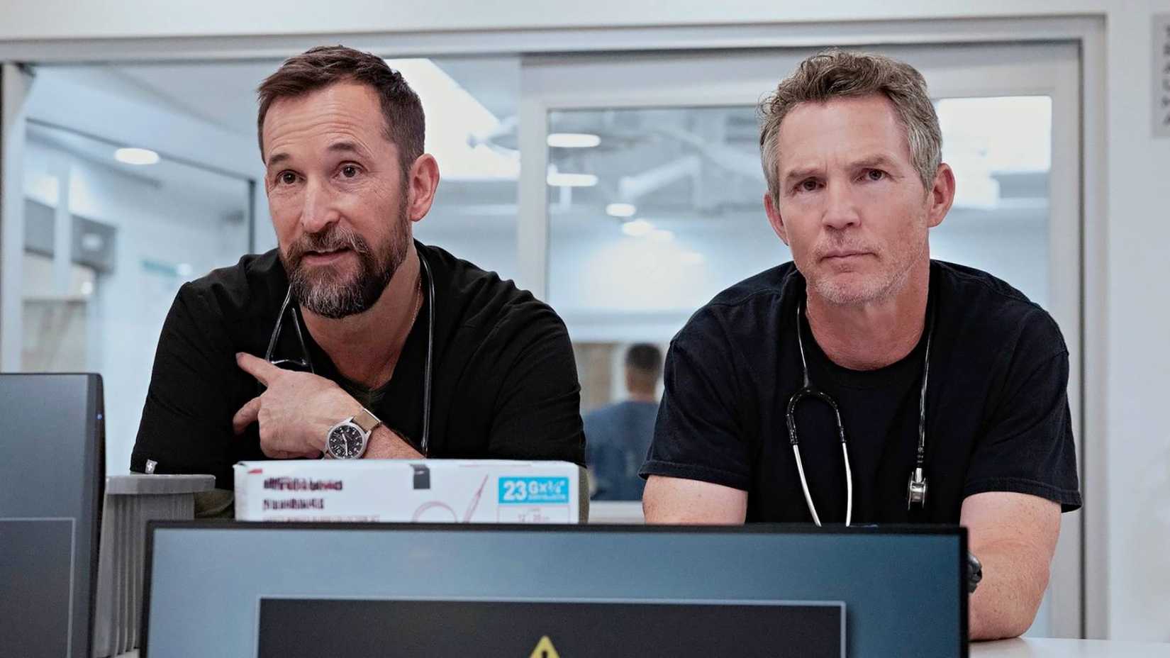 Robby and Jack leaning on the counter together talking in The Pitt.