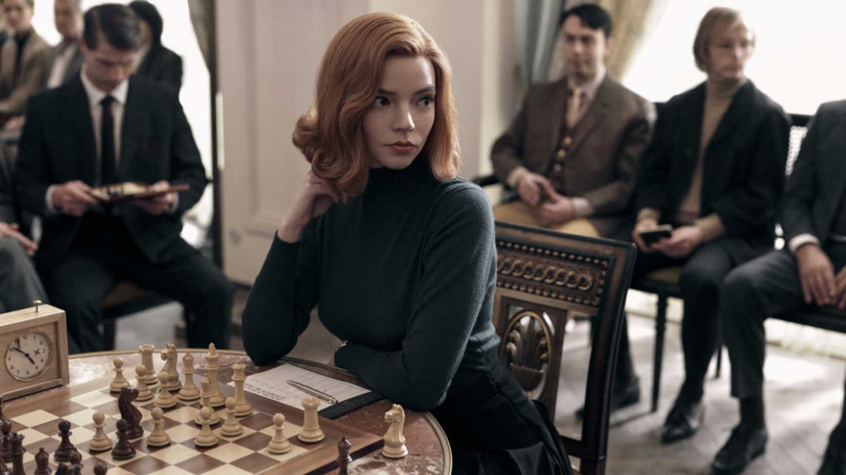 Beth sits at a chess table in The Queen's Gambit