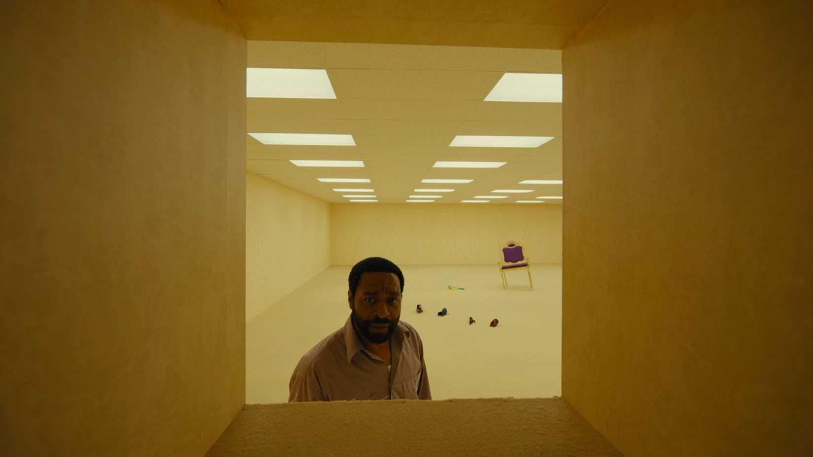 Chiwetel Ejiofor looks down crawlspace in Backrooms