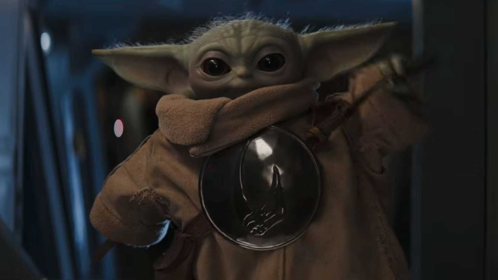 grogu tightening his strap in the mandalorian and grogu movie