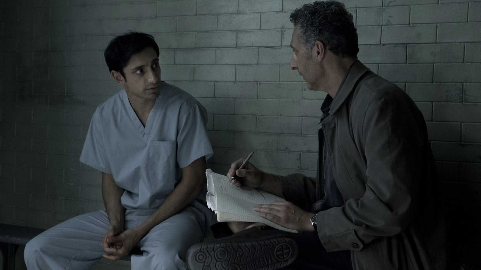 Naz and John sit in a prison cell, talking intensely, in The Night Of.