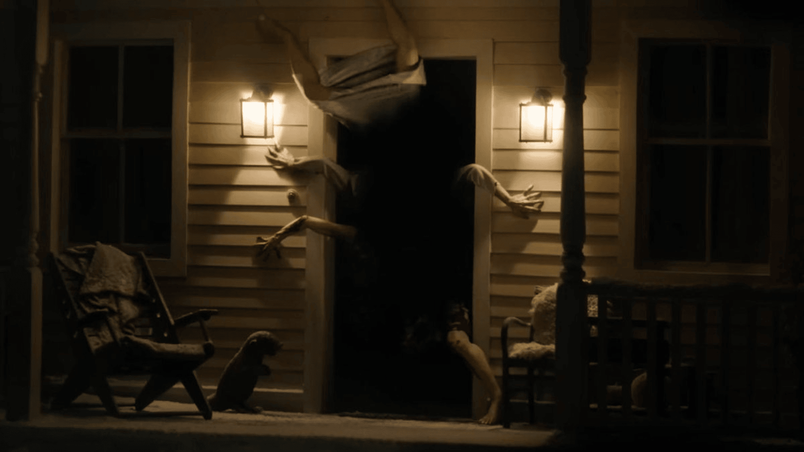 Limbs reaching through a door in Resident Evil teaser trailer 2026