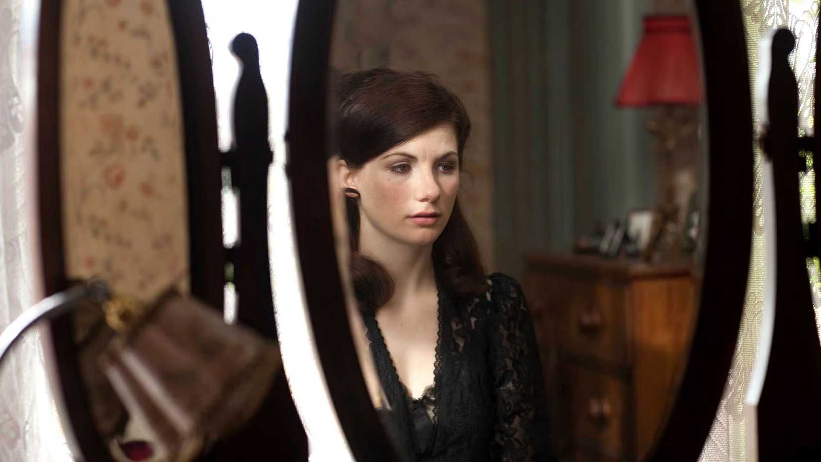 Jodie Whittaker as Ruth Bowen looking upset as she sits at her dressing table dressed in black in Marchlands.