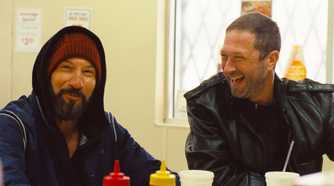 Mikey and Richie at a diner laughing together in Gary on The Bear