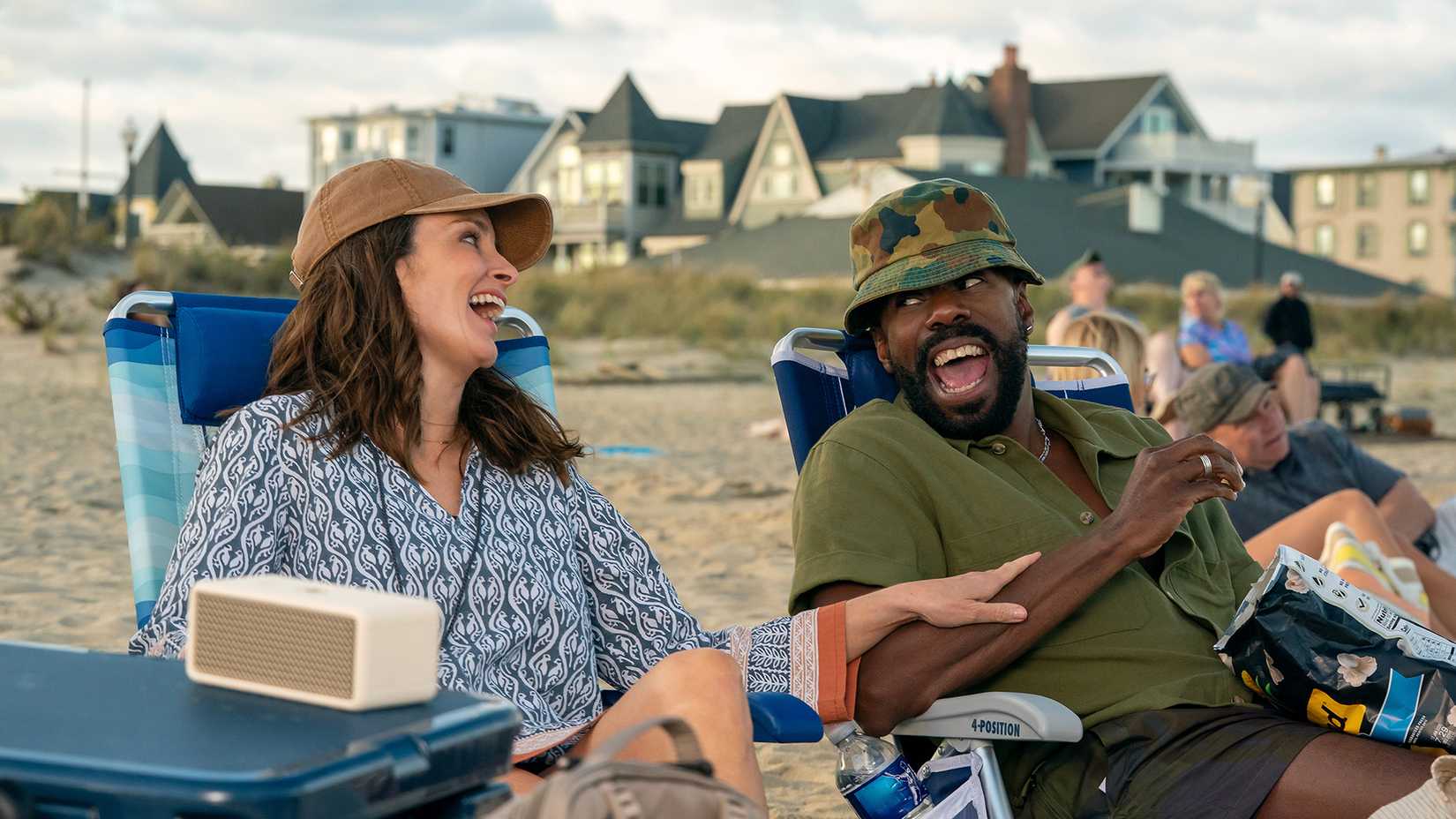 Kate and Danny on the beach laughing in The Four Seasons.