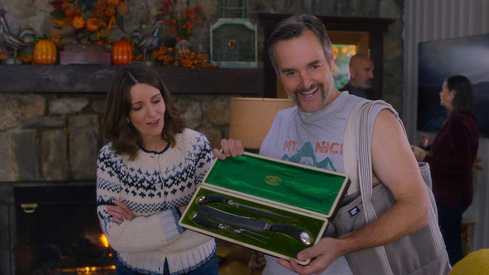 Jack showing friends a carving knife in a box as Kate looks on in The Four Seasons.
