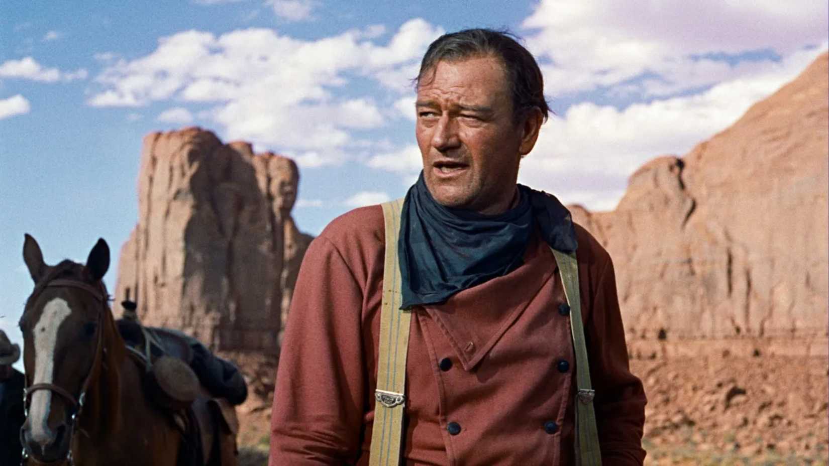 Ethan stands by a horse in The Searchers
