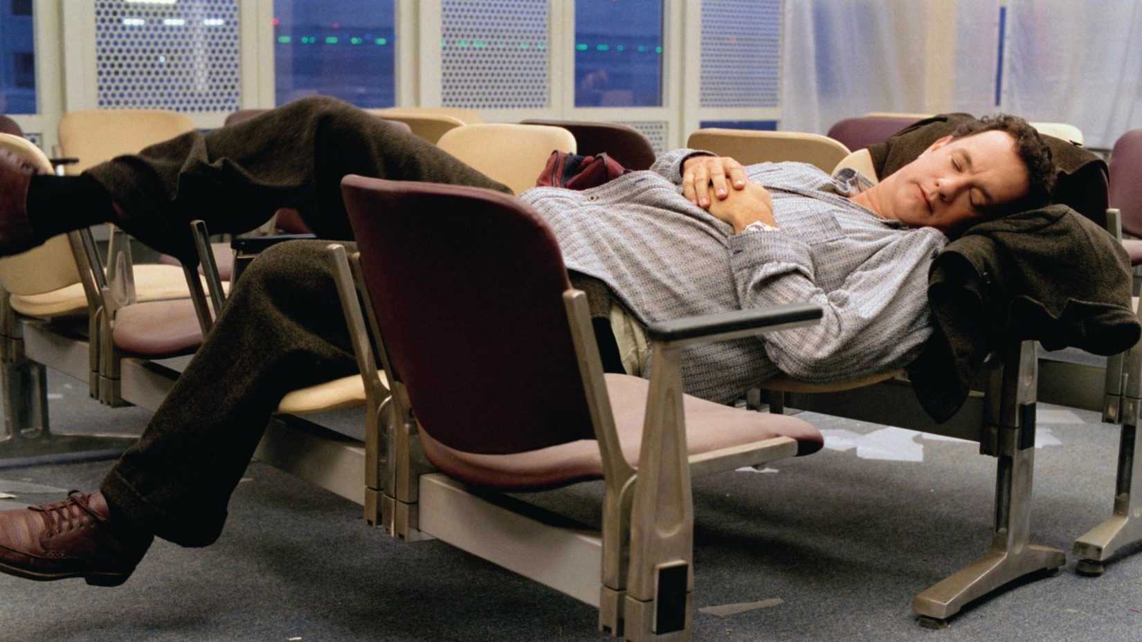 Viktor sleeps on chairs in The Terminal
