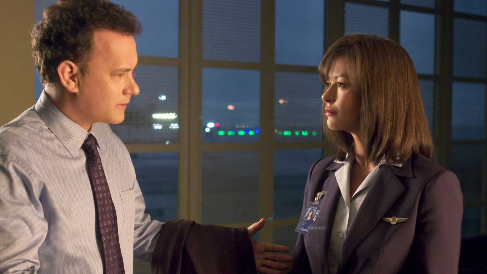 Viktor and Amelia talk by a window in The Terminal