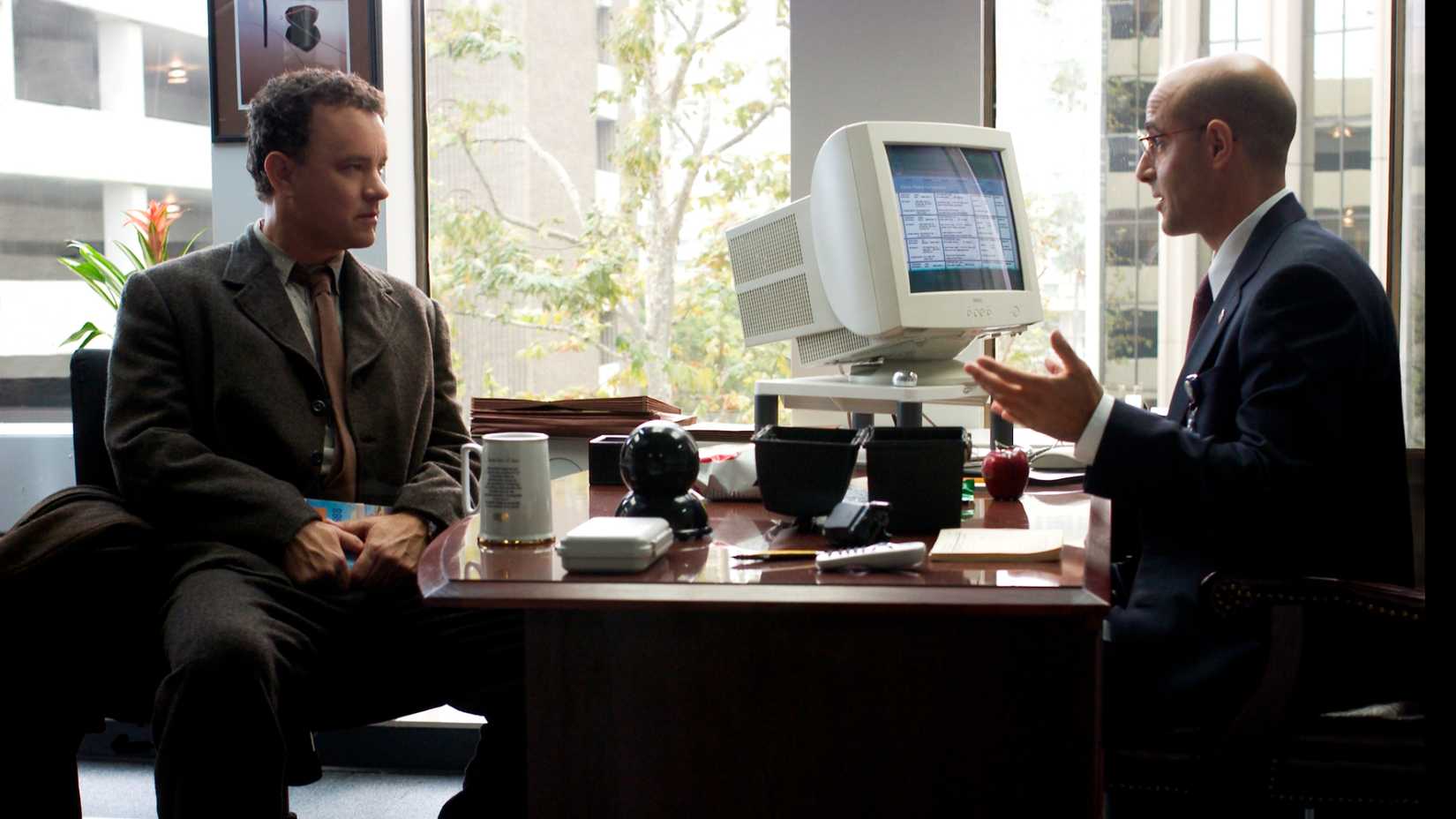 Viktor and Frank sit across from each other in The Terminal